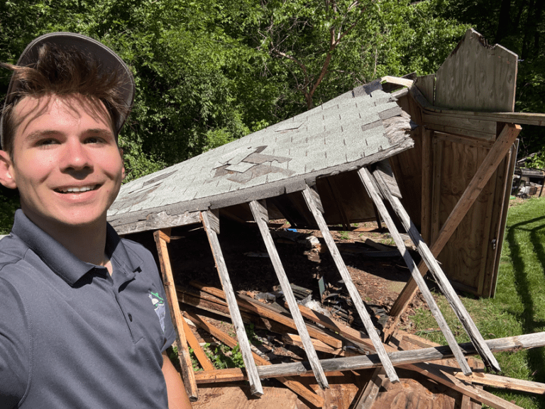 Emory from Junk Knights standing with a shed he tore down