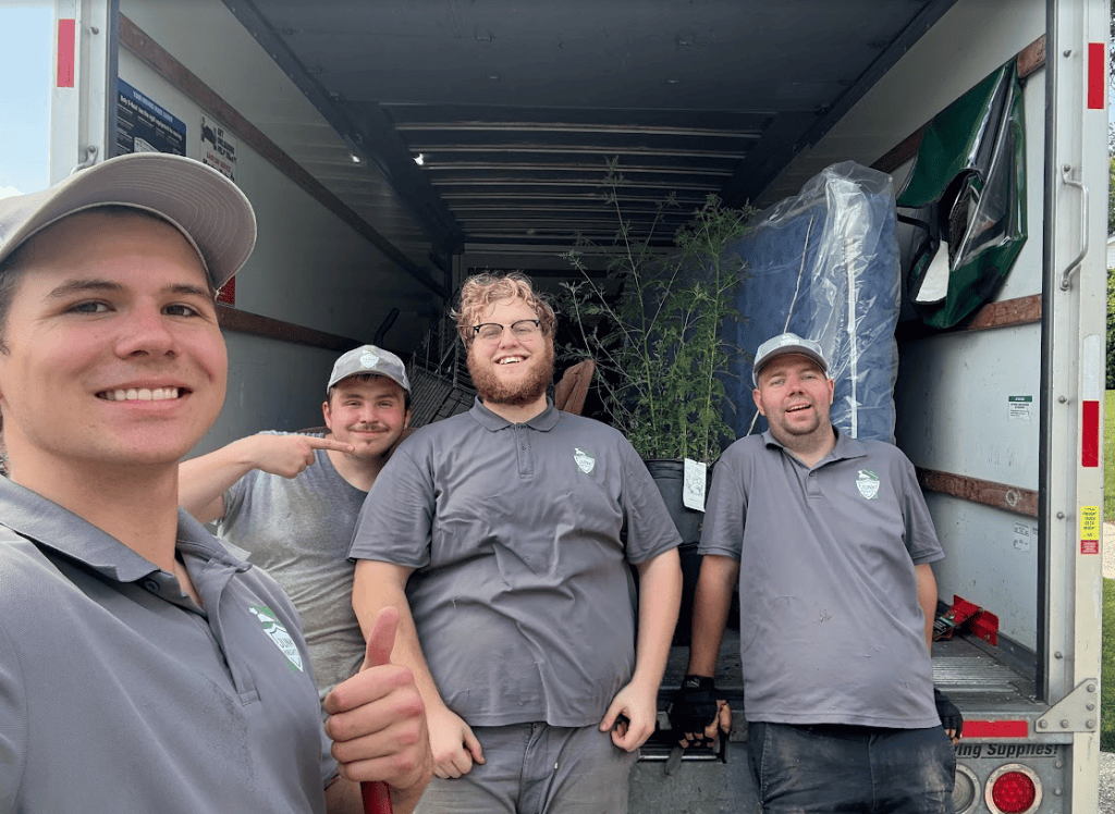 The Junk Knights crew — four local team members in front of the truck