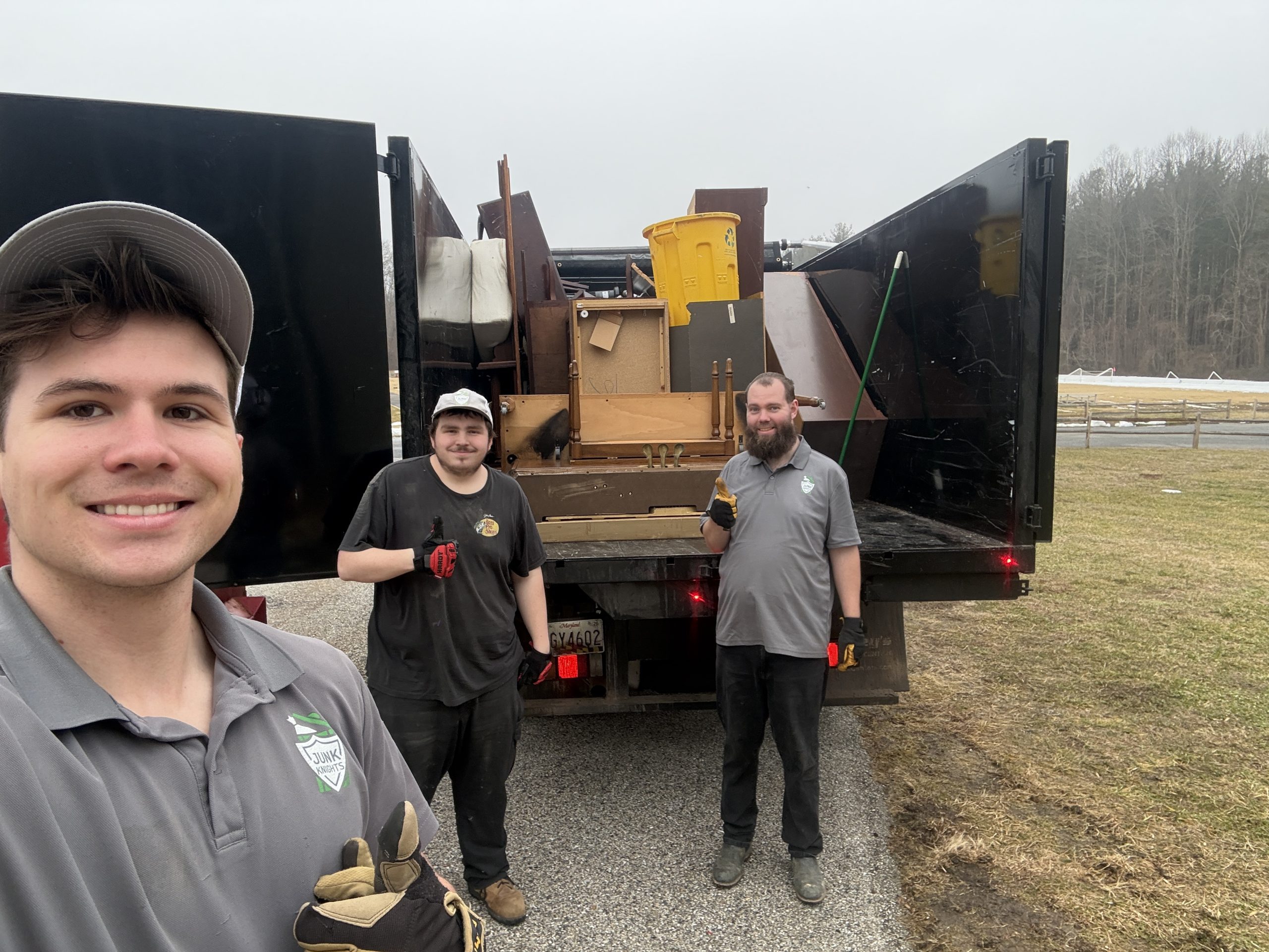 Junk Knights crew standing with the truck