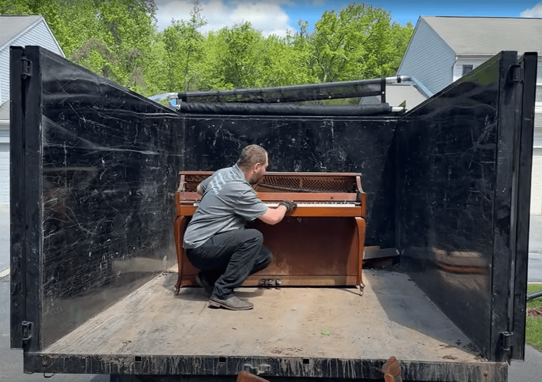 Devin with a piano loaded in the Junk Knights truck