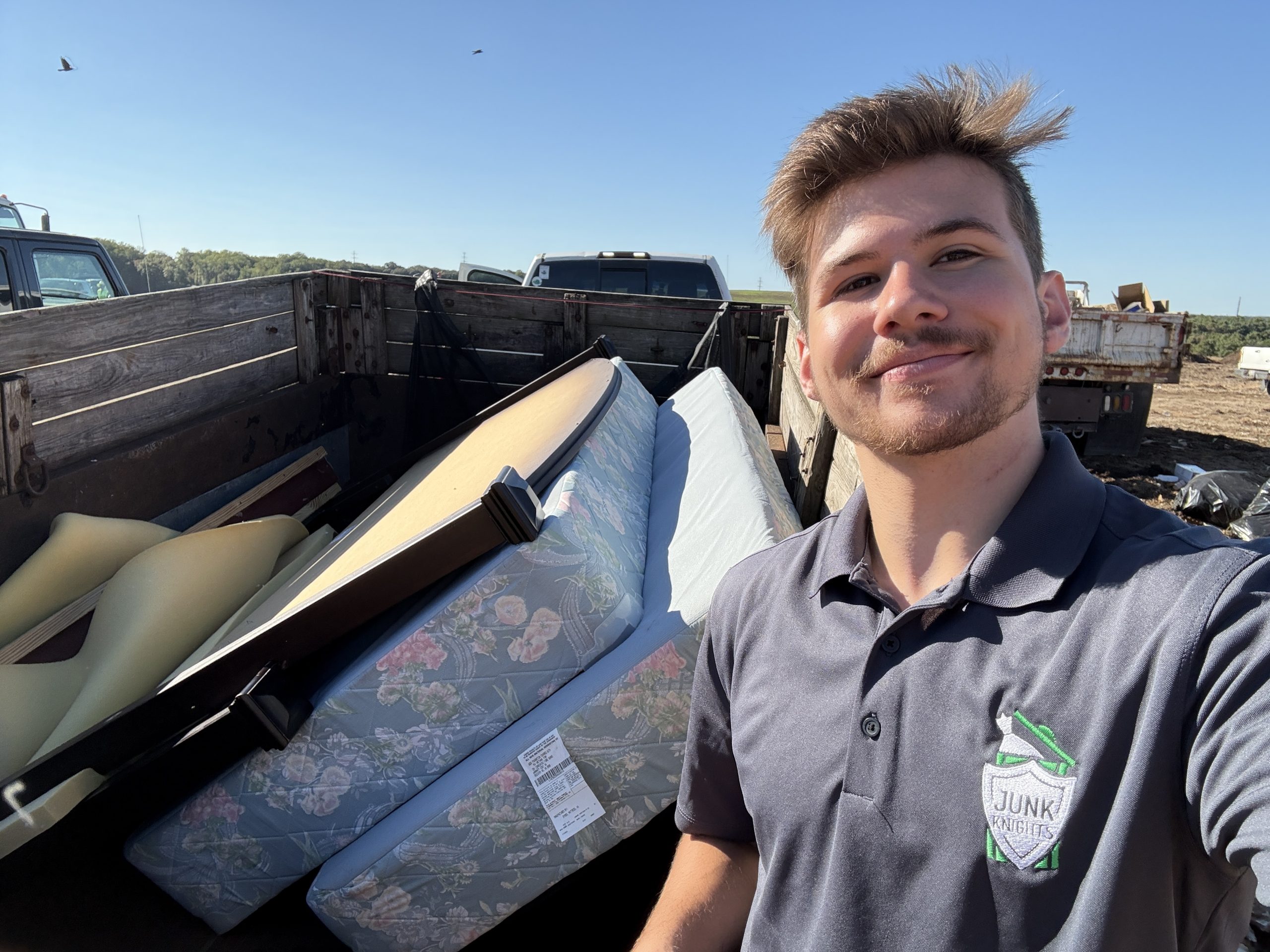 Emory smiling with mattresses loaded