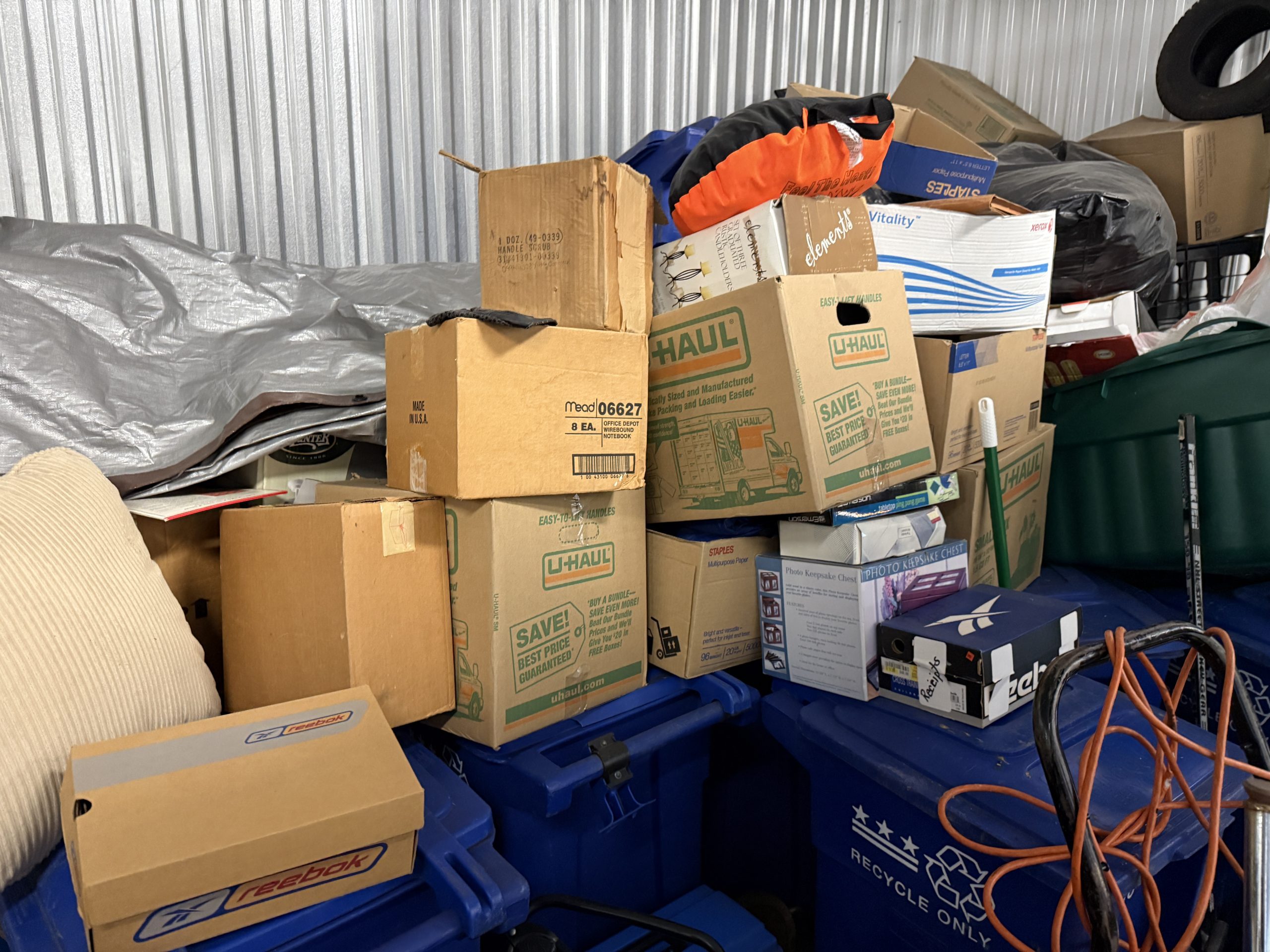Storage unit packed with old boxes and tubs