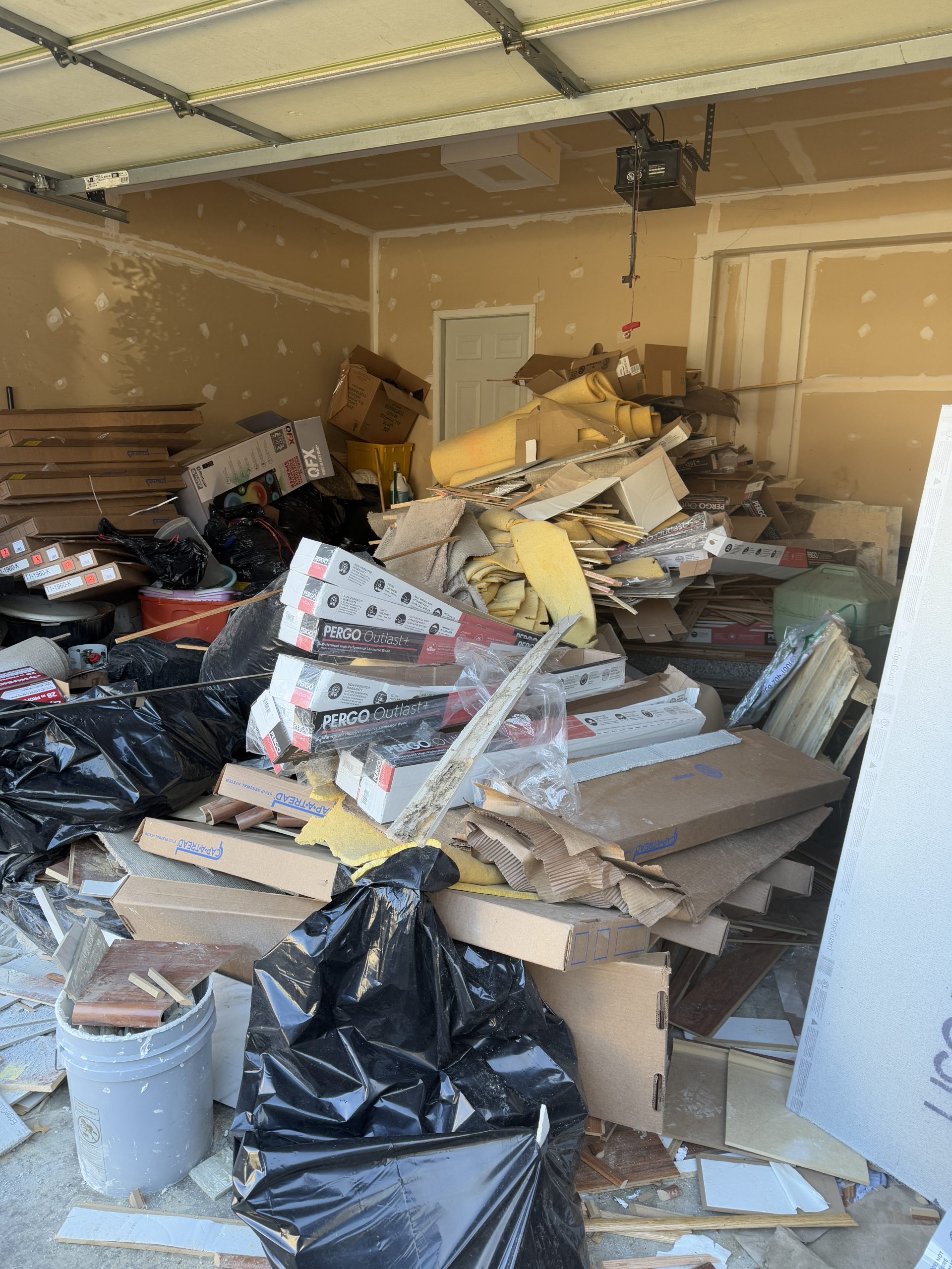Old flooring and construction debris in garage