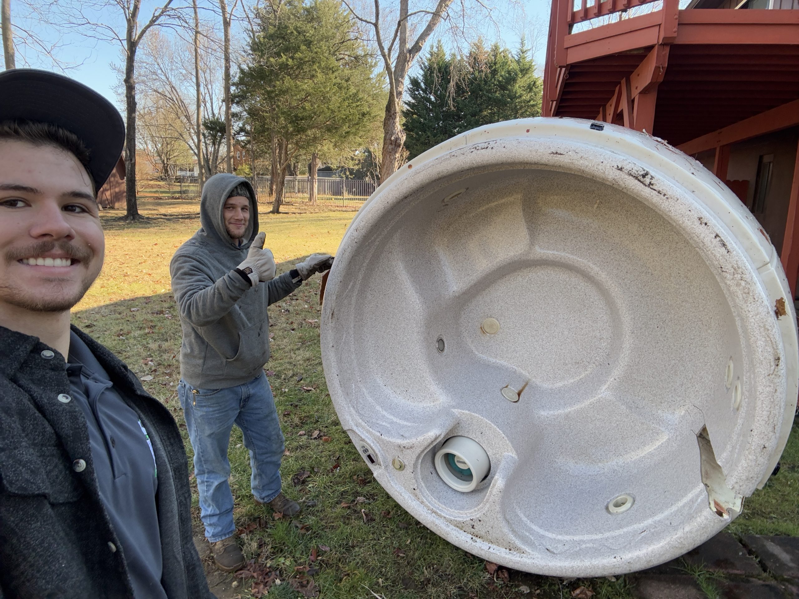 Zach and Emory removing a hot tub